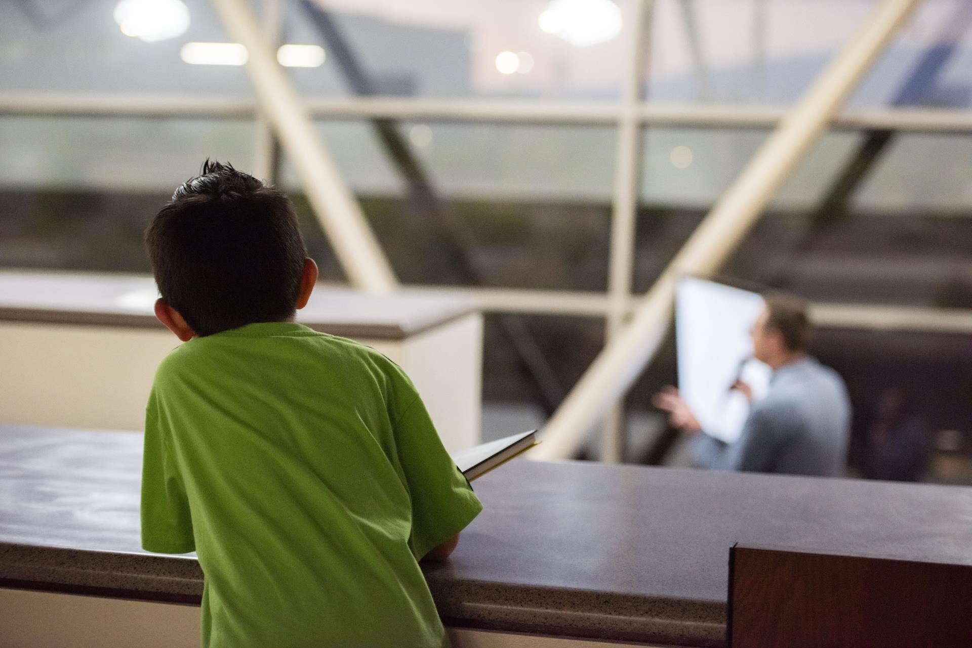 Child looking over balcony.