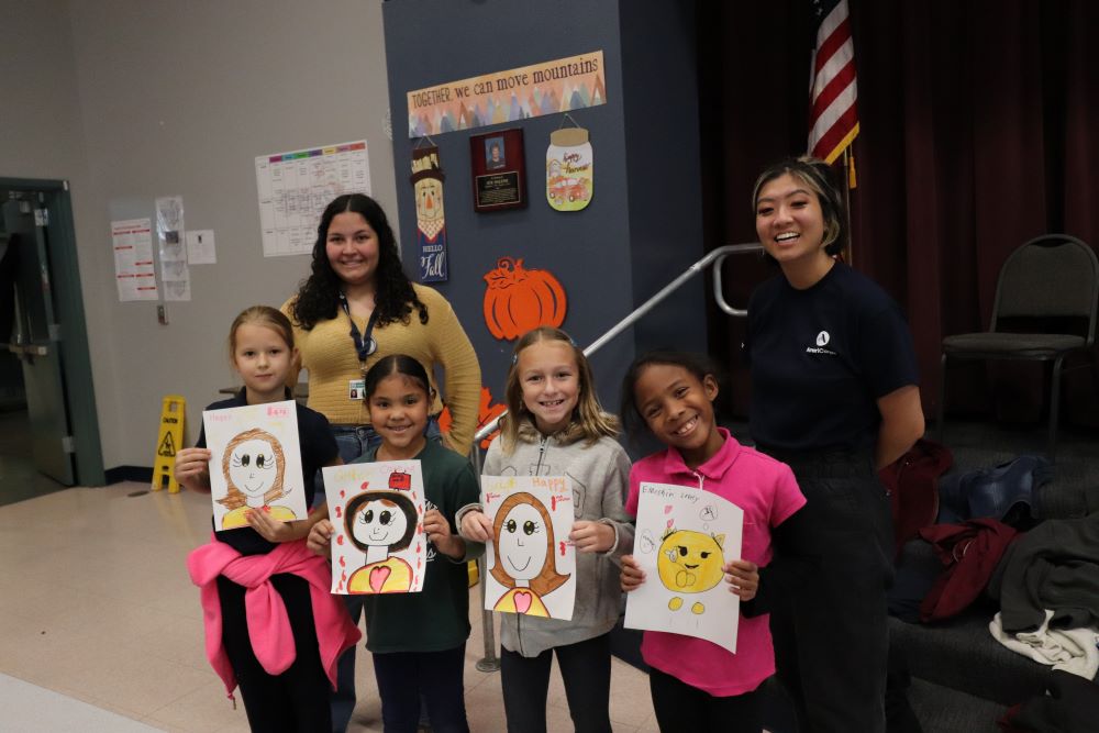 2024 AmeriCorps members with students.