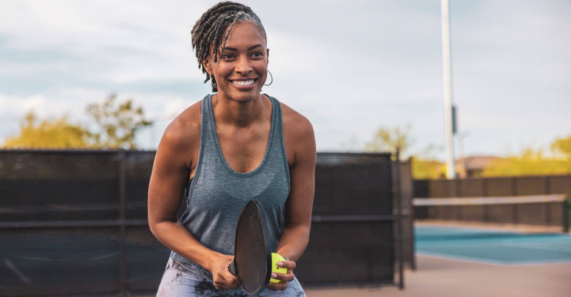 Outdoors Pickleball Court with senior woman.