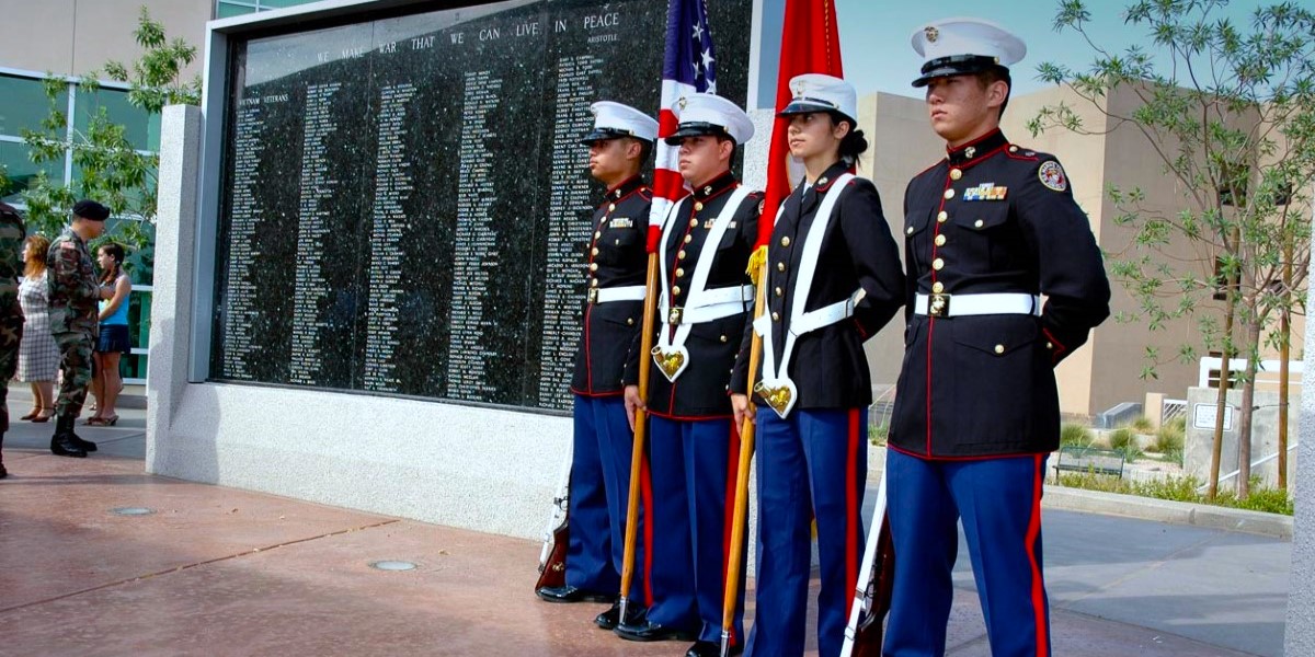 JROTC standing at Veteran Memorial Wall.